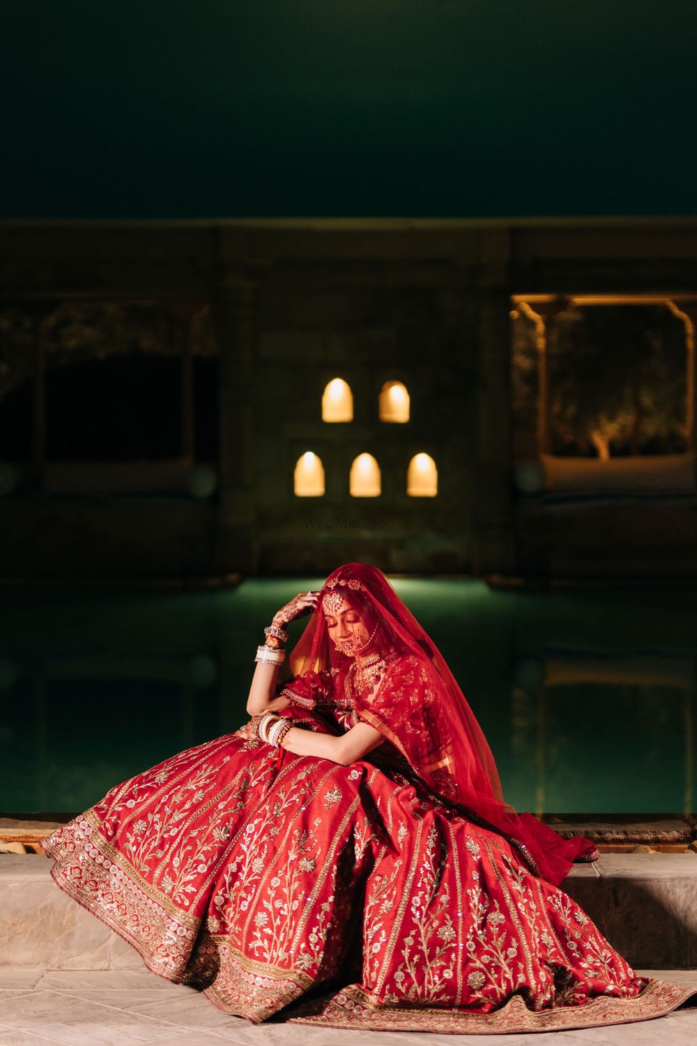 Photo of bride on her wedding day in red lehenga