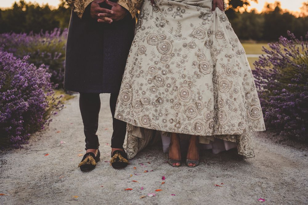 Photo of Bride and groom portrait showing shoes