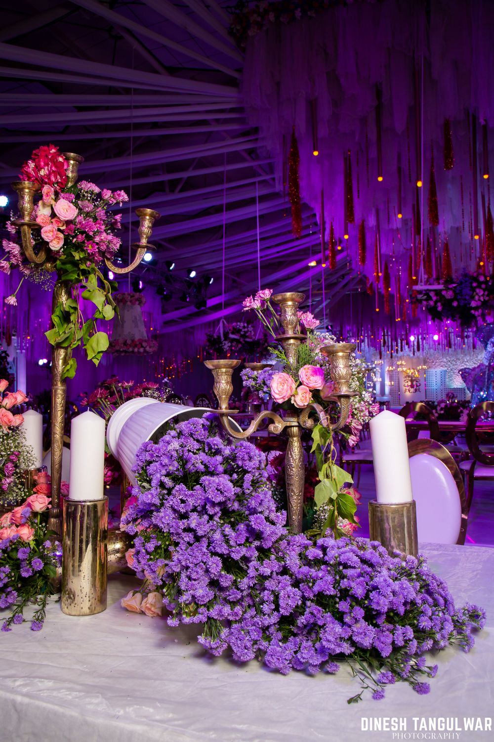 Photo of Pretty and elaborate floral decor for reception in shades of purple