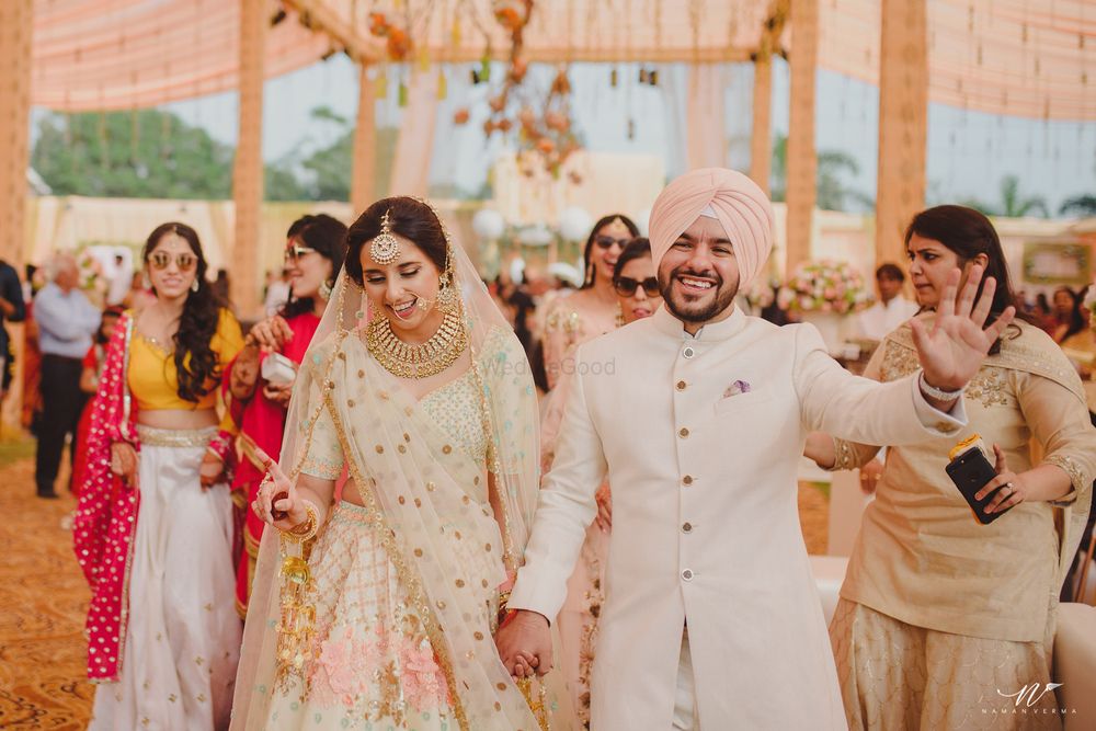 Photo of Coordinated Sikh bride and groom in white