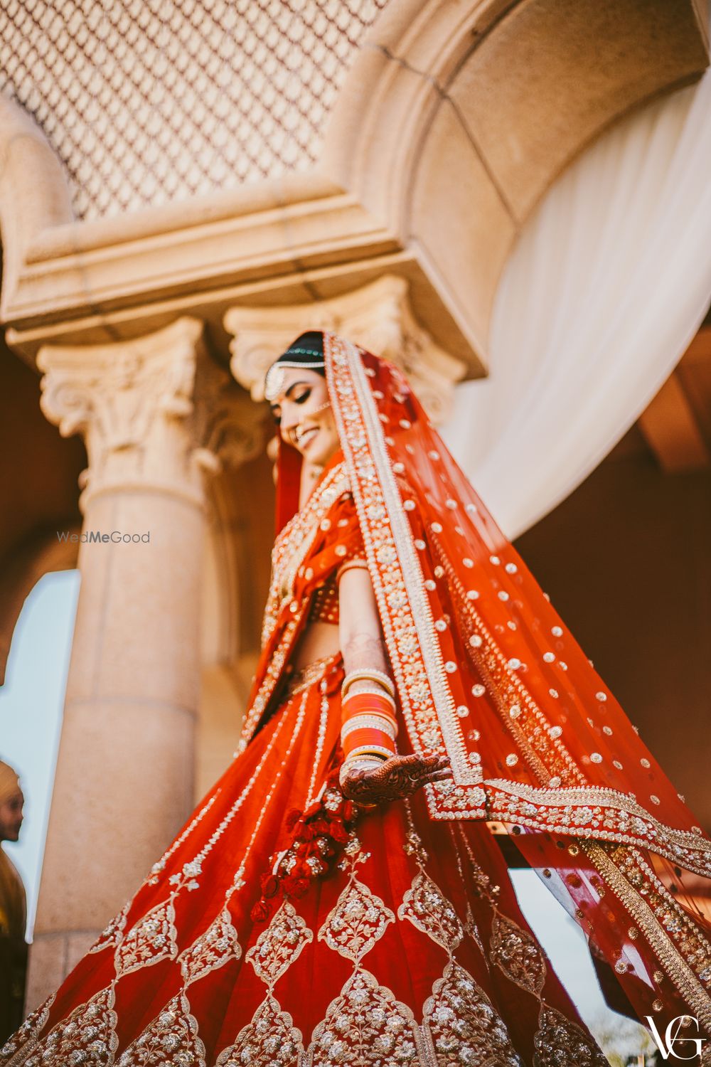 Photo of Wedding day bridal portrait in her red and gold sabyasachi lehenga