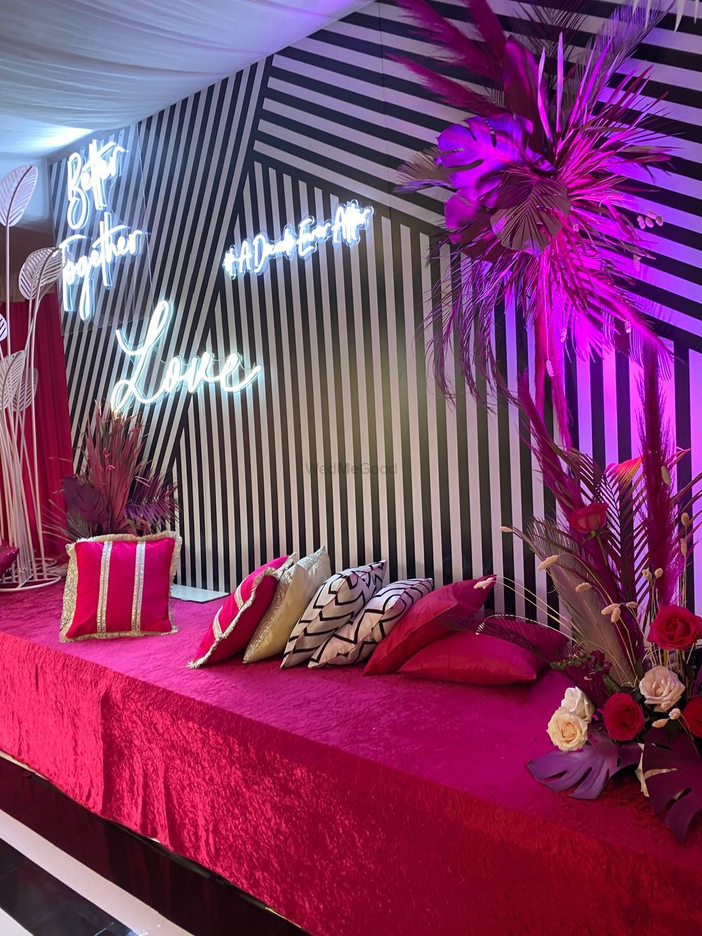 Photo of pink white and black sangeet decor idea with neon lights