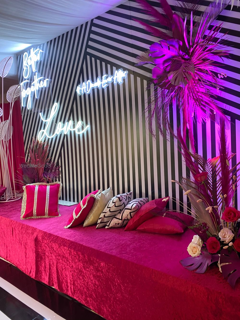 Photo of pink white and black sangeet decor idea with neon lights