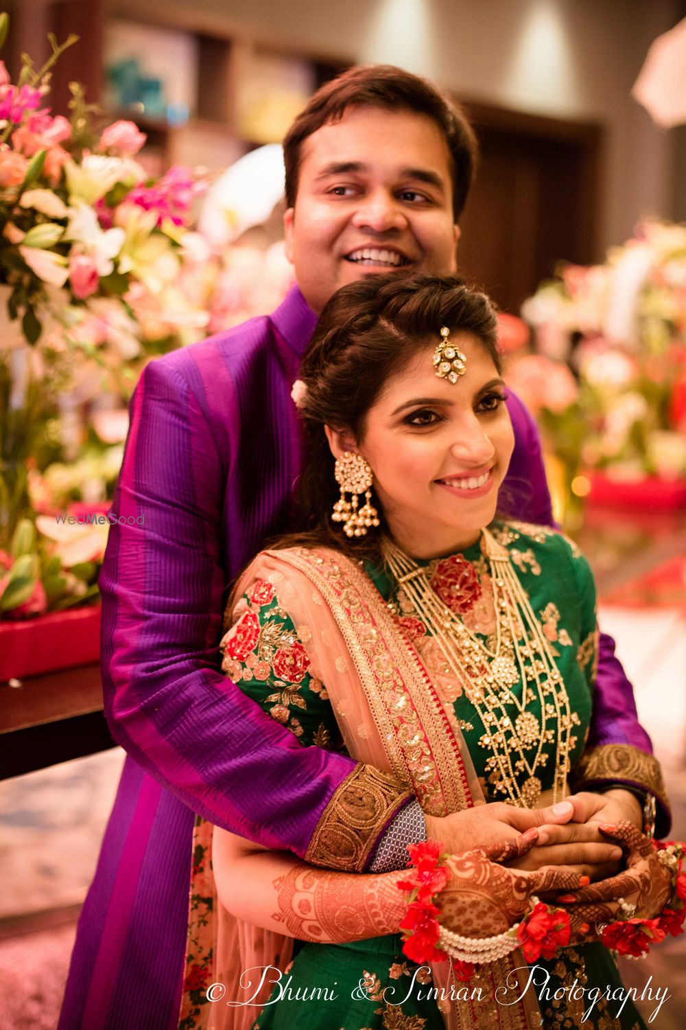 Photo of Bride and groom contrast outfit on sangeet