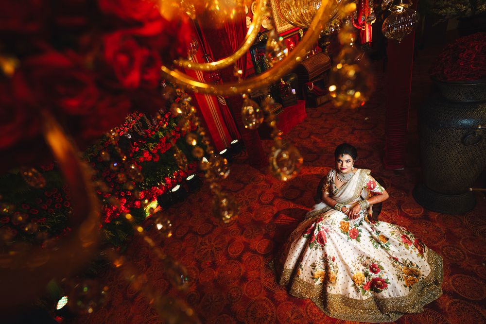 Photo of Top shot of bride in floral sabya lehenga