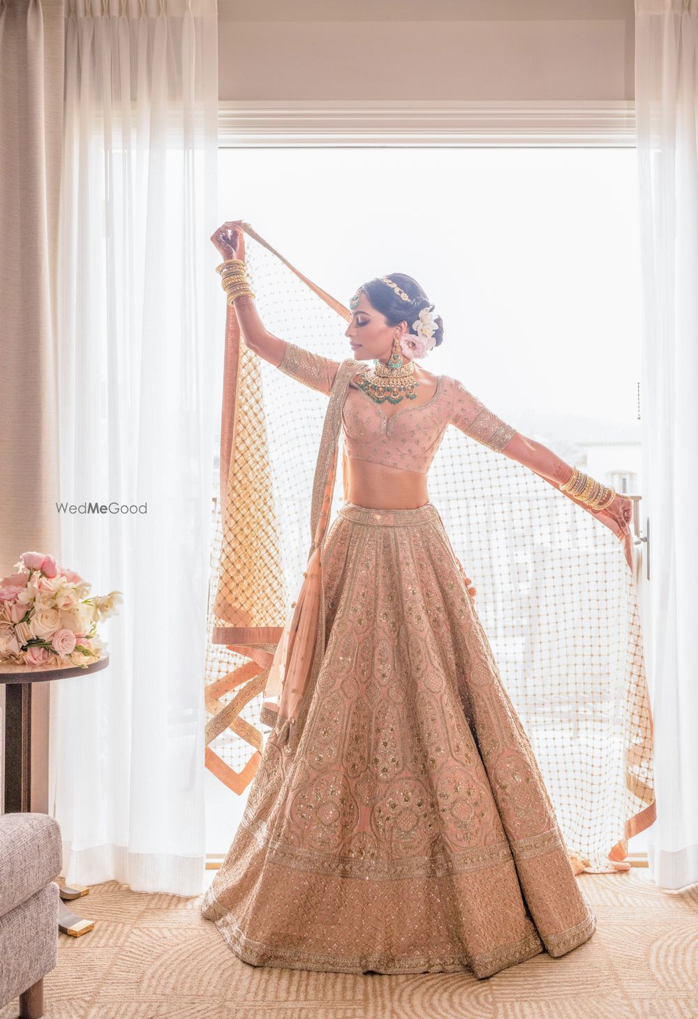 Photo of Bride in pastel sabyasachi lehenga getting ready shot