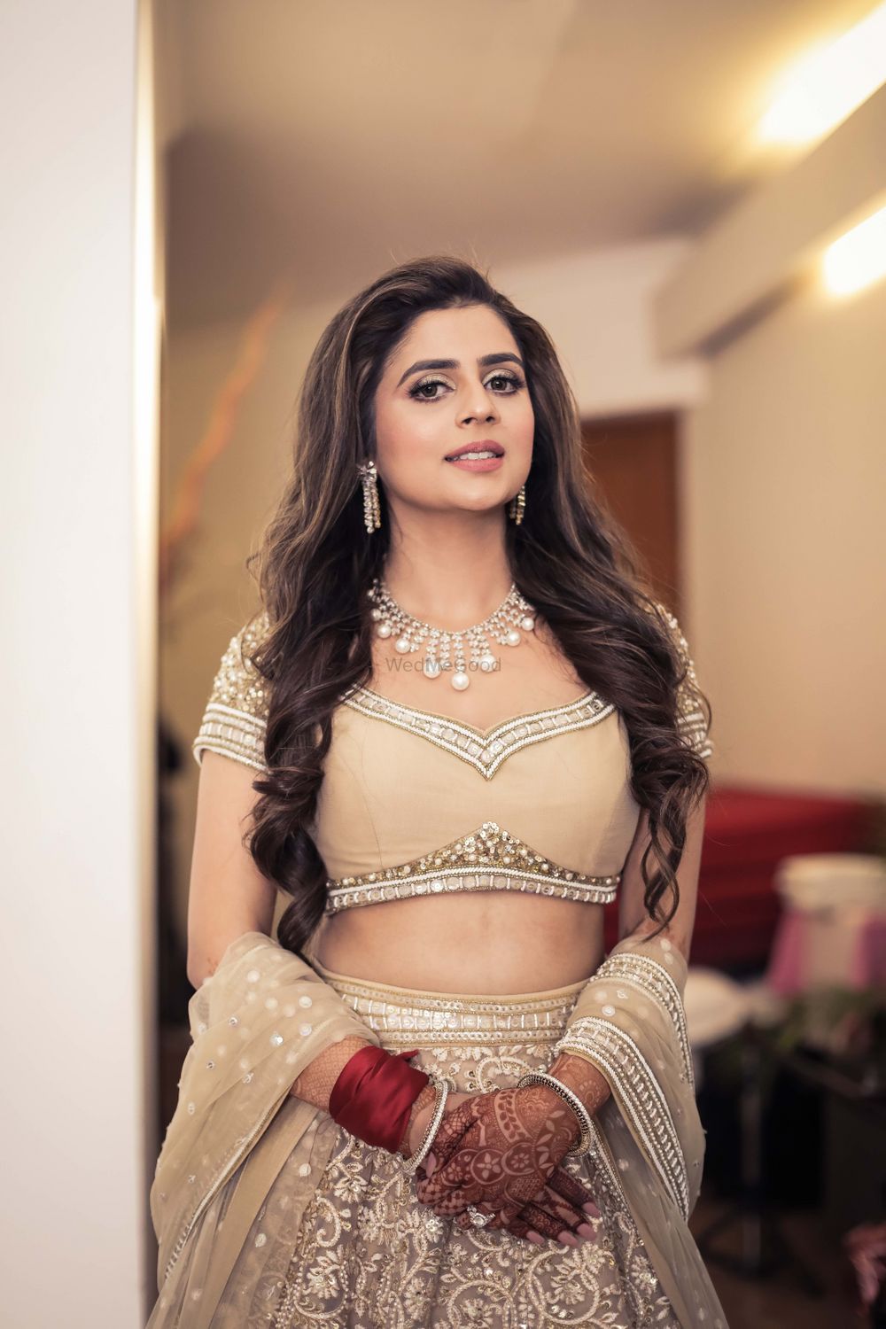 Photo of bride on engagement with beige lehenga and long hair