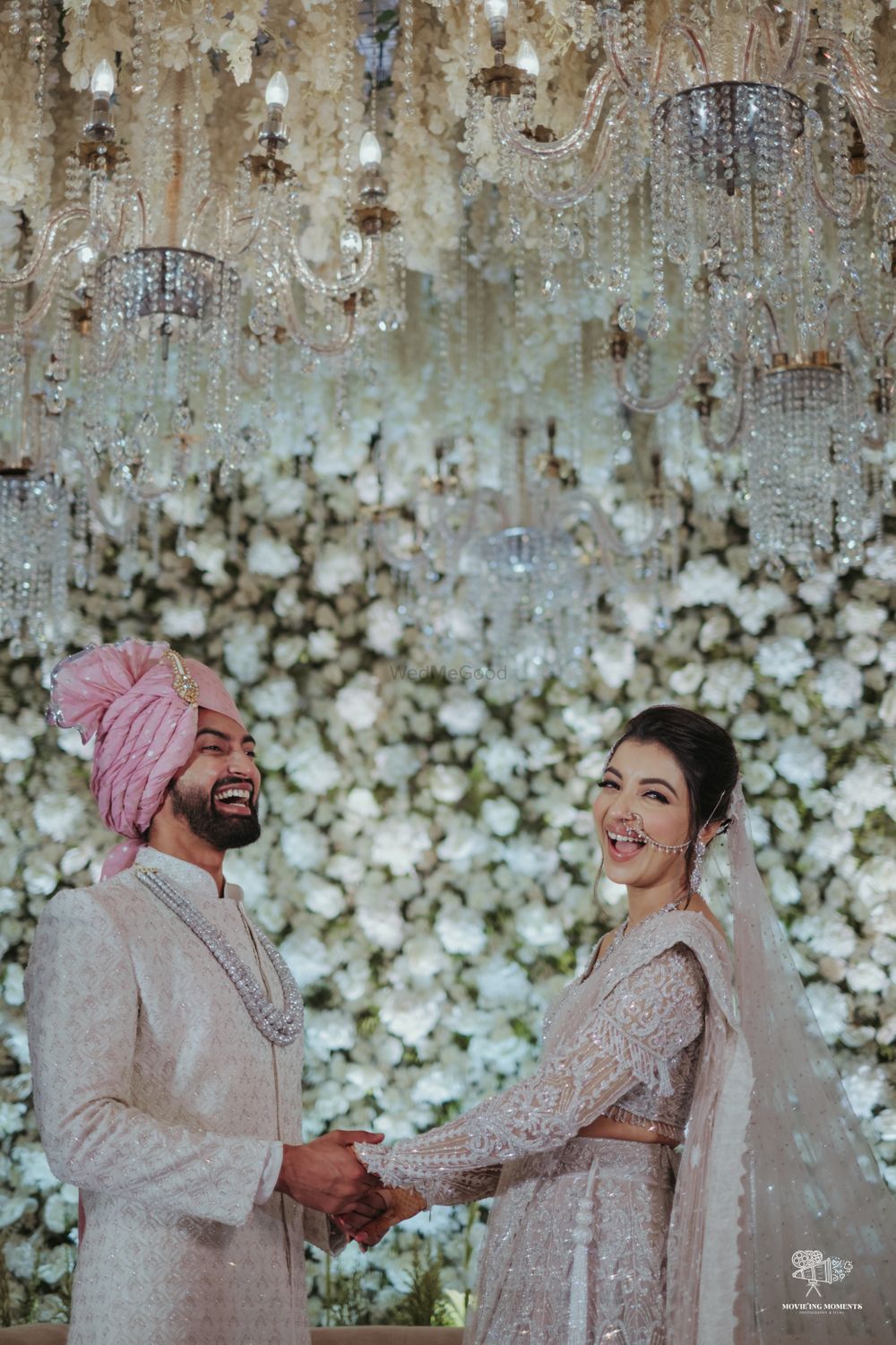 Photo of Happy couple shot against a floral wall backdrop