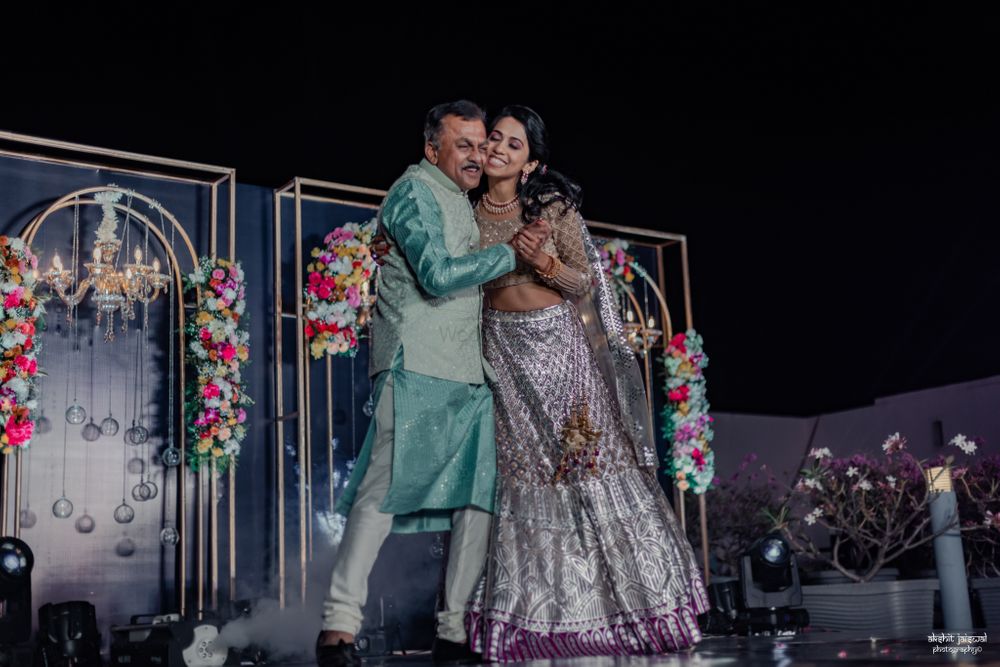 Photo of Happy bride and her father dancing at the Sangeet