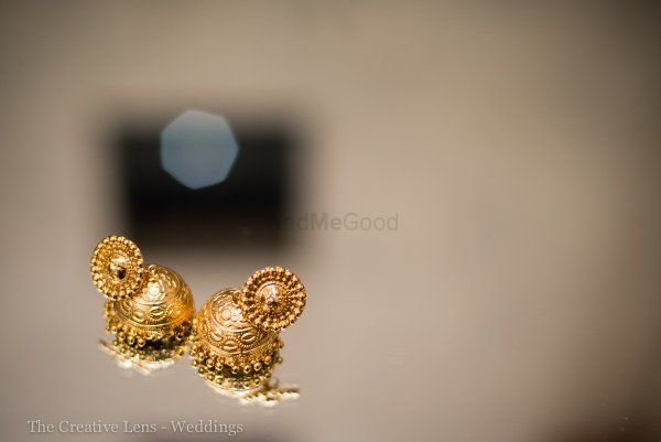 Photo of delicate gold jhumkis