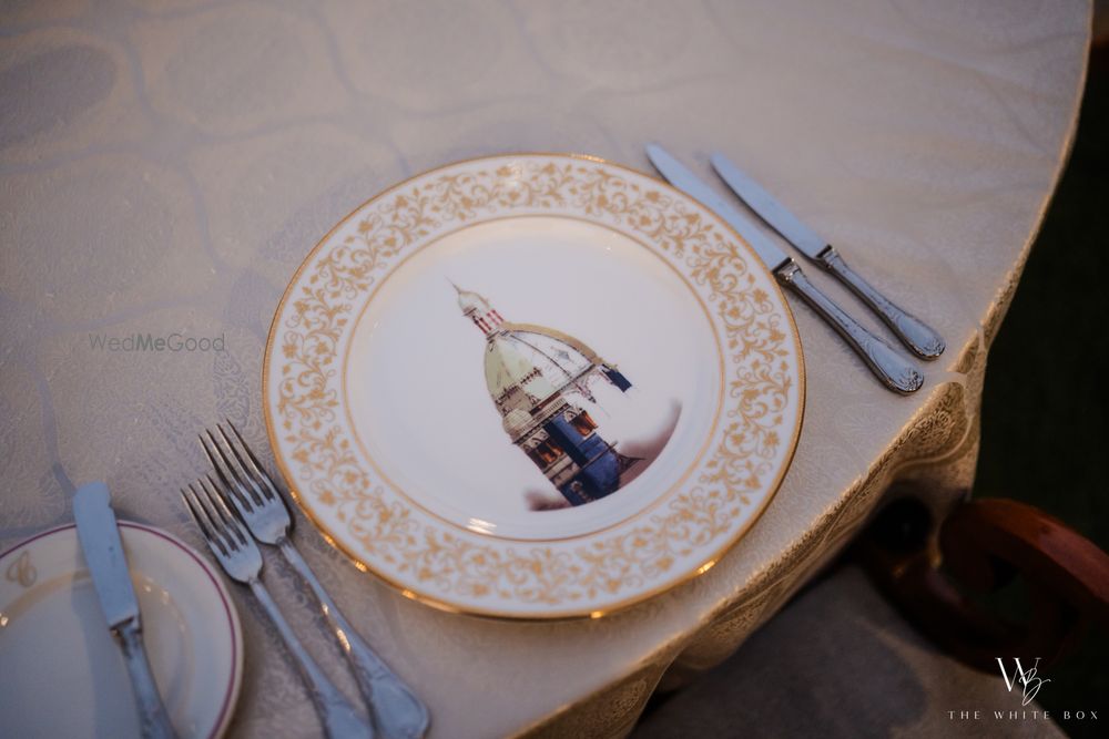 Photo of Gorgeous plate setting for a wedding with gold and white details.