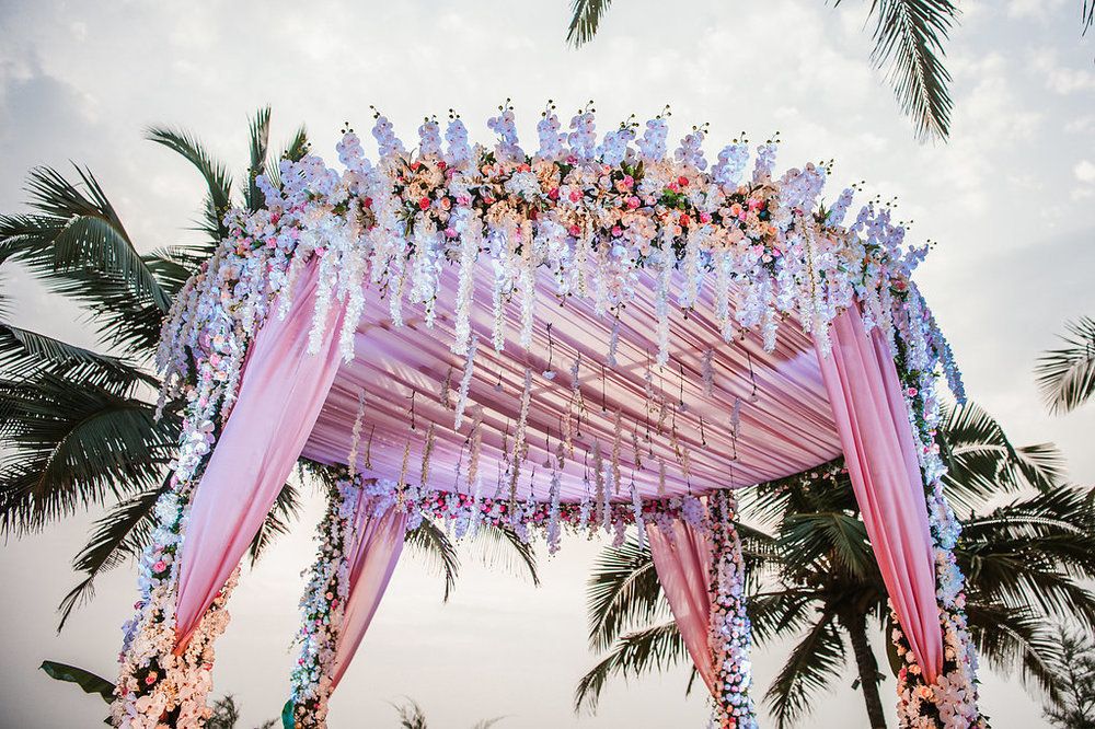 Photo of Circular mandap decor with florals and light pink fabric