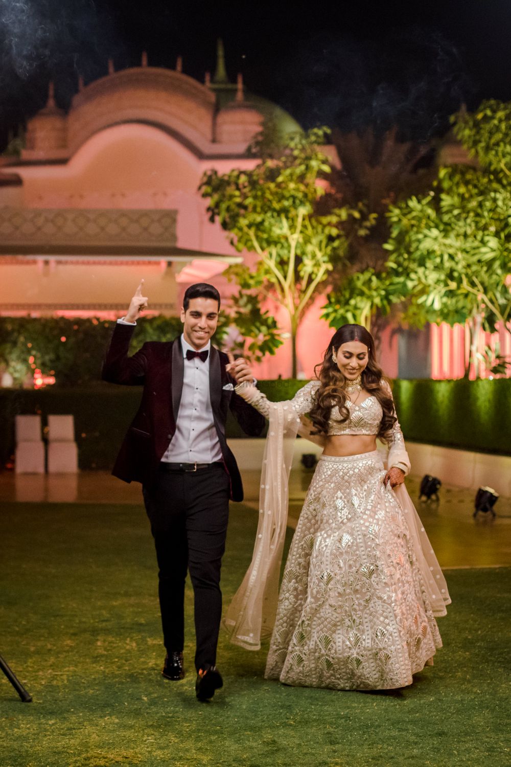 Photo of Bride and groom walking hand in hand on their reception