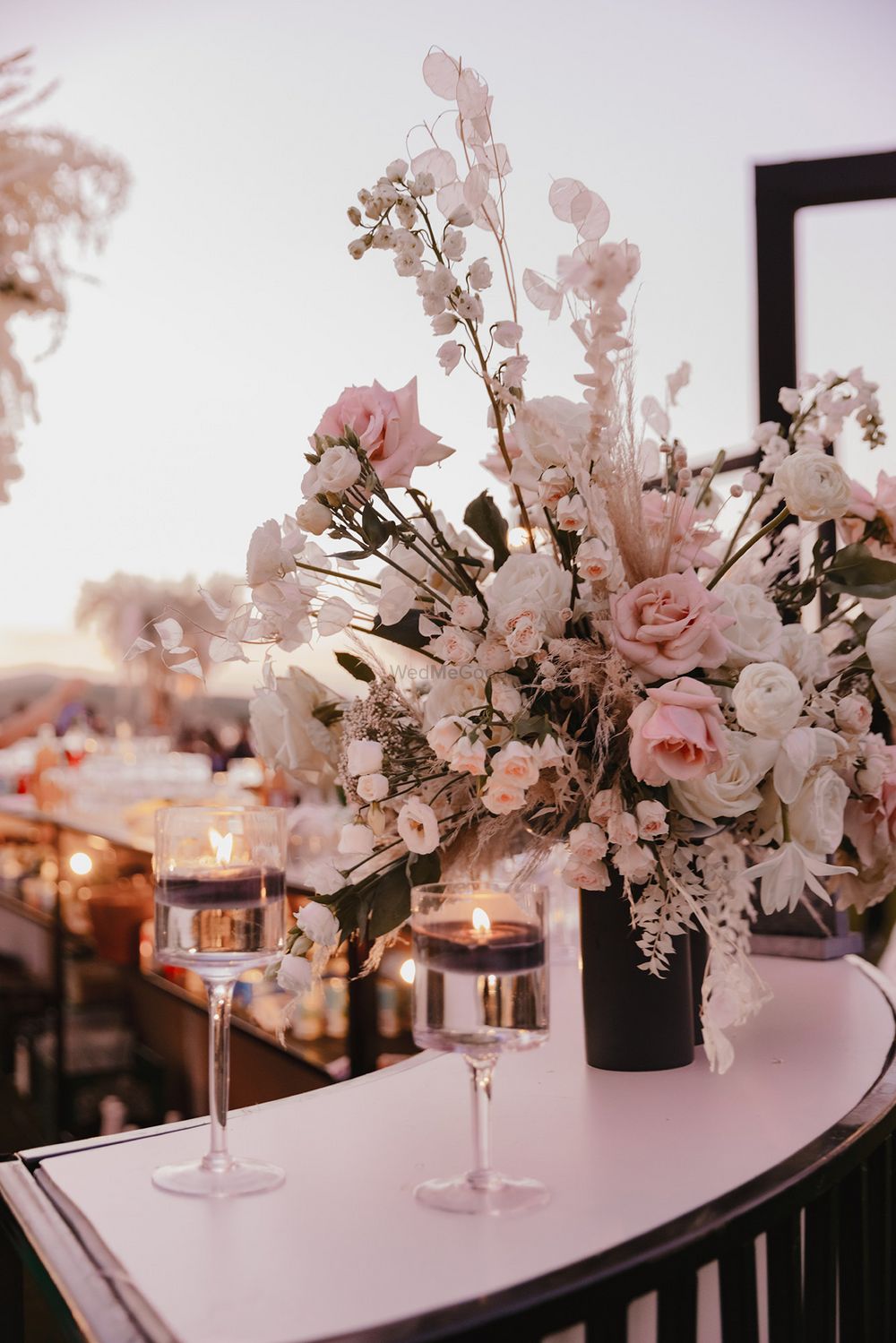 Photo of Beautiful baby pink and white floral with black centerpieces with candles