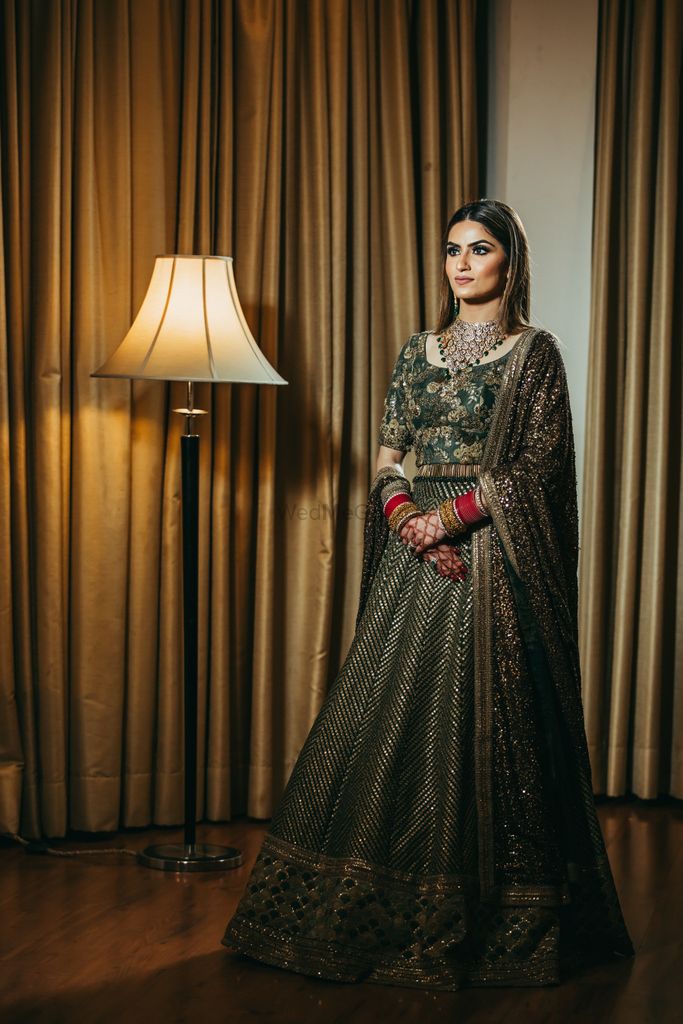 Photo of A bride in a shimmery grey lehenga for her reception