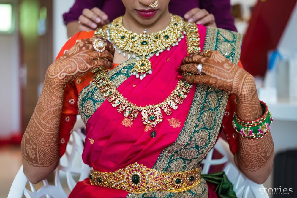 Photo of South Indian bridal jewellery with layered necklaces and waist belt