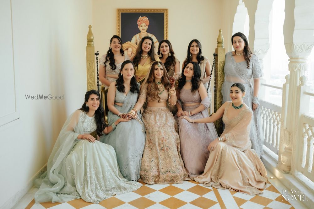 Photo of Fun group shot of the bride and her bridesmaids on the wedding day, all co-ordinated in pastel outfits