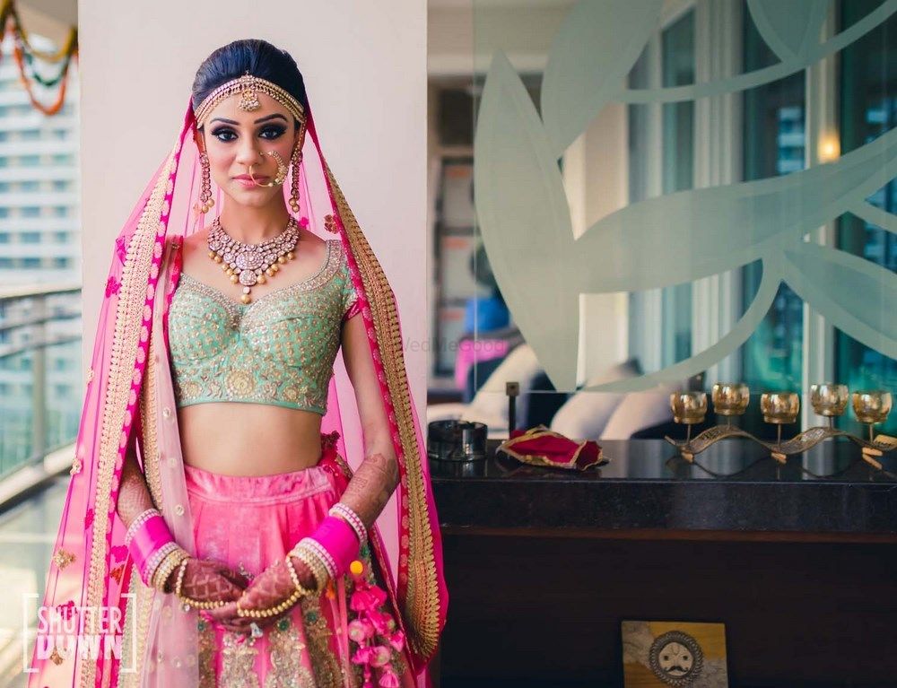 Photo of Bright pink and mint bridal lehenga with unique blouse design