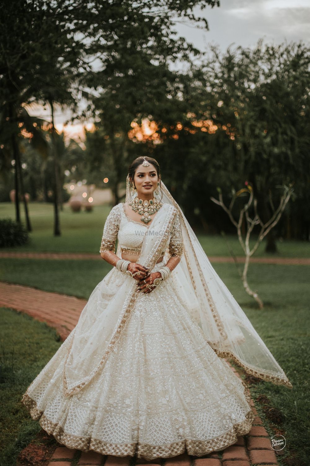 Photo of all white bridal lehenga with gold embroidery