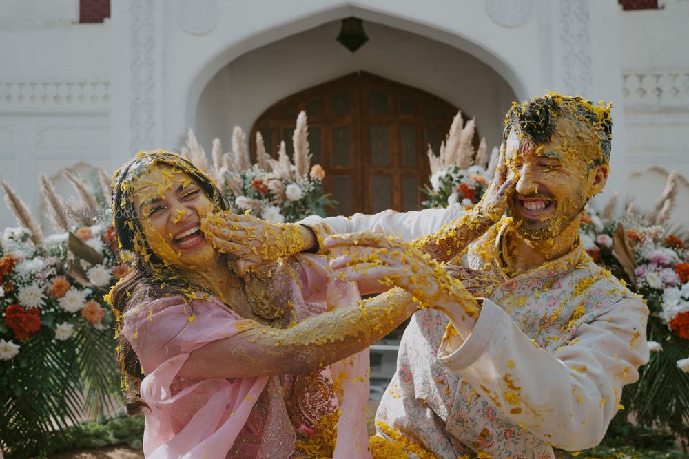 Photo of Fun haldi photo with the bride and groom smeared with haldi