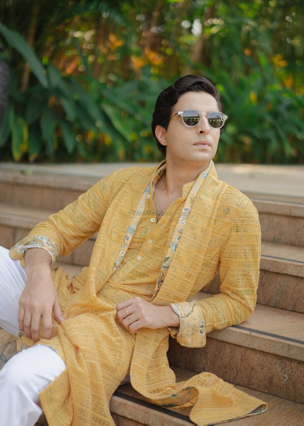 Photo of Dashing groom portrait in an ochre yellow floral kurta and sunglasses