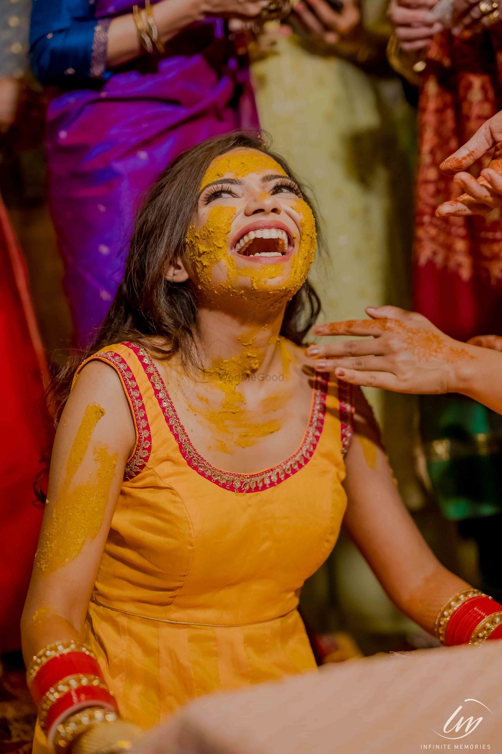 Photo of A bride laughs during her haldi ceremony