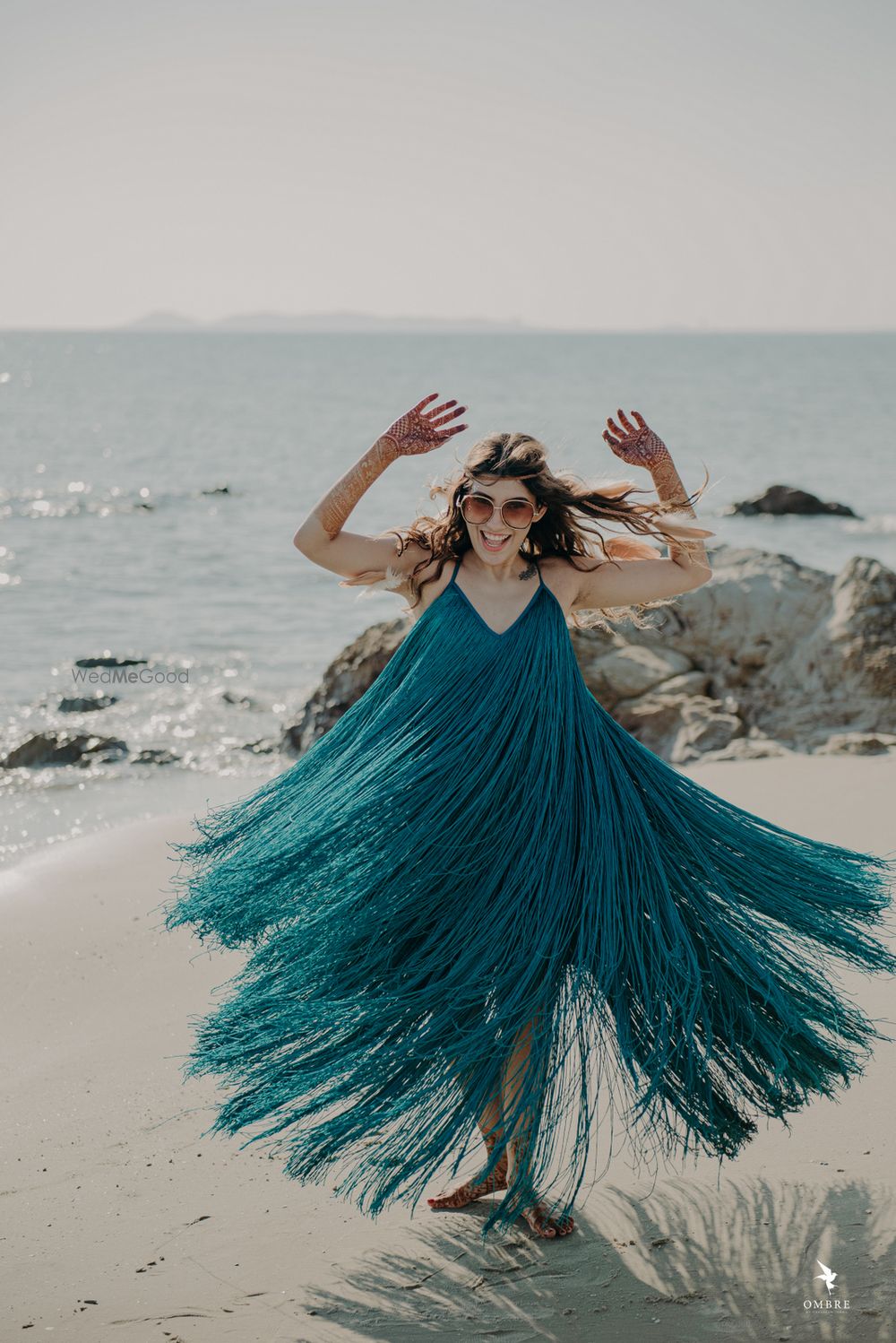 Photo of The bride in a flowy outfit perfect for the pool party