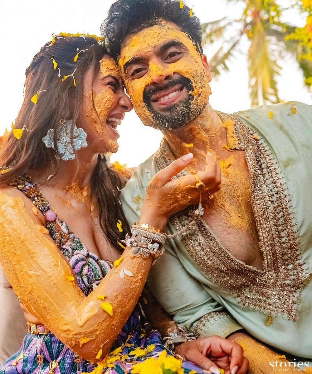 Photo of Fun haldi photo of the couple smeared in haldi with bride in some unique accessories