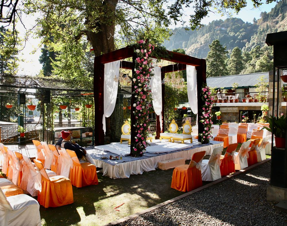 Photo of Open mandap decorated with flowers in outdoor settings