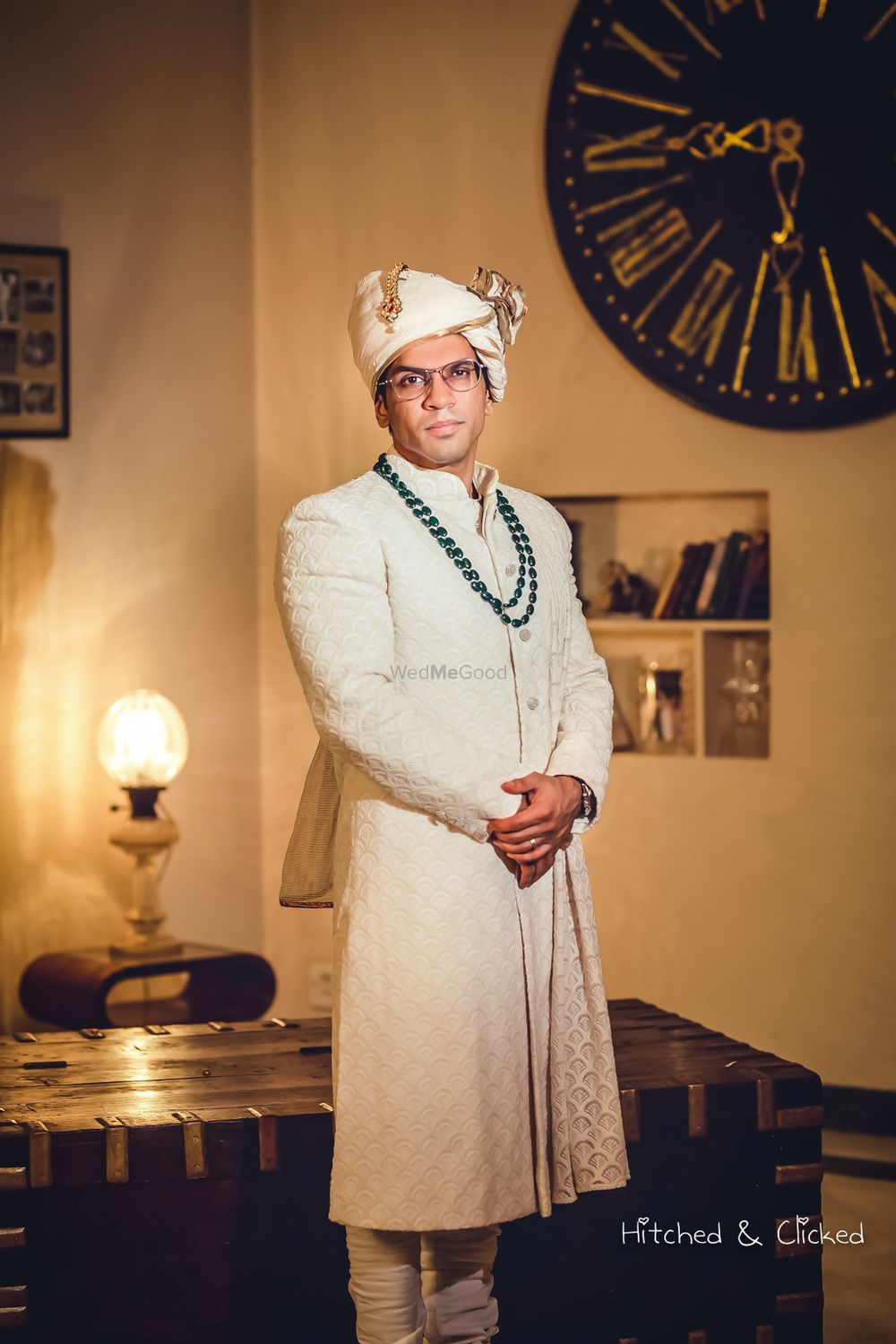Photo of Groom in off white sherwani and green necklace
