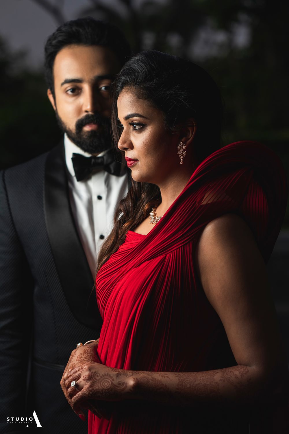 Photo of Couple portrait with bride in red gg gown