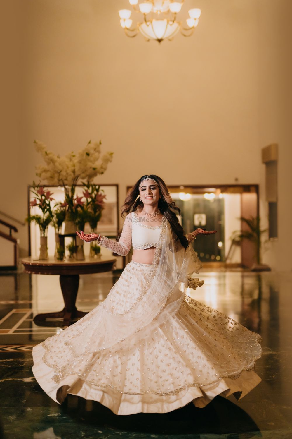 Photo of Bride twirling in a Sangeet lehenga