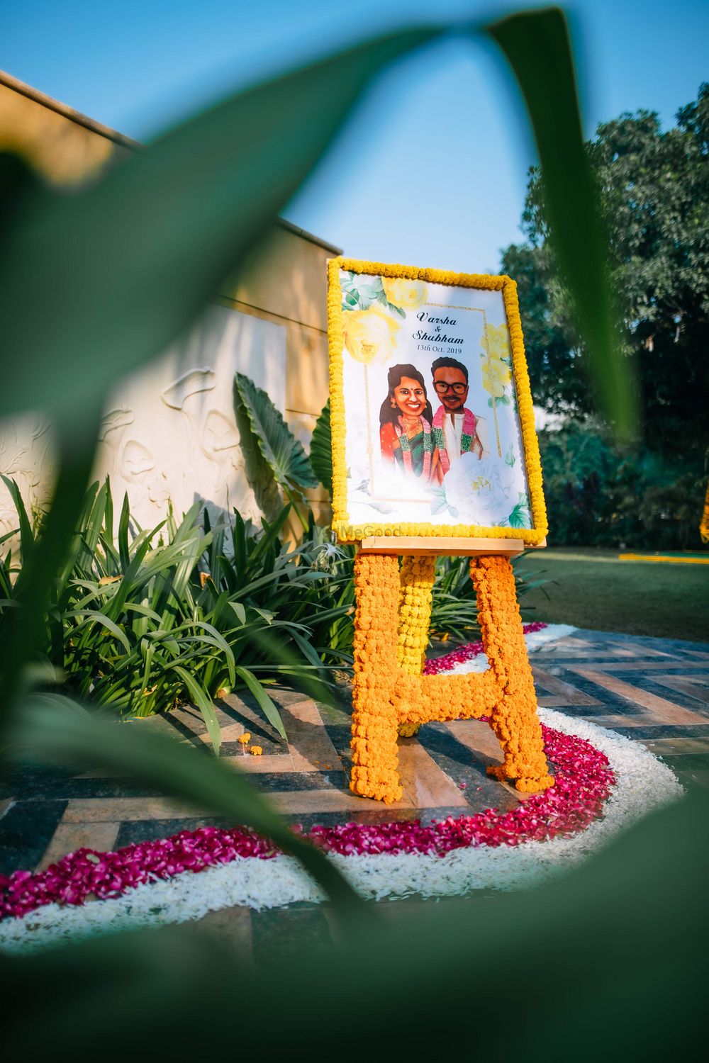 Photo of Fun welcome signage with the couple's portraits.