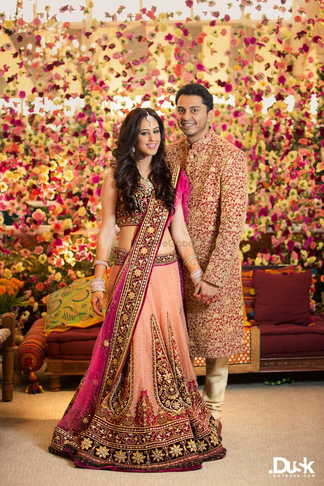 Photo of Floral backdrop with indian bride and groom
