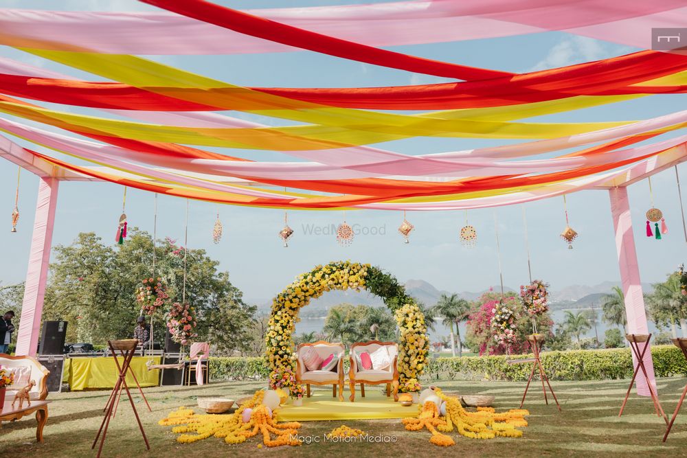 Photo of Fun and colourful decor with drapes and flowers for an outdoor event