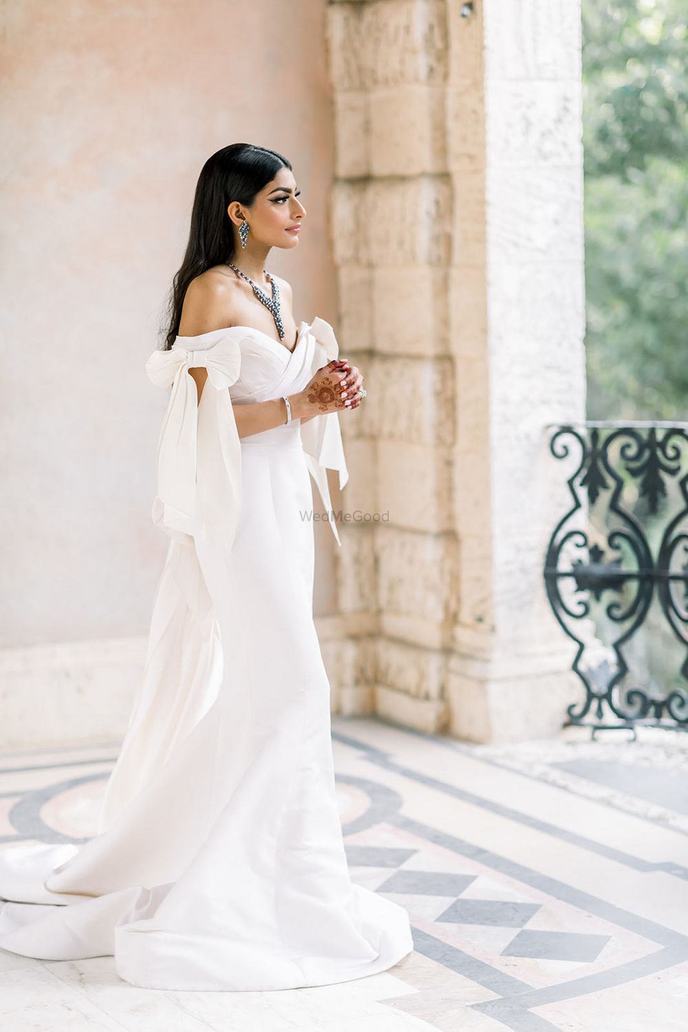 Photo of Off shoulder white wedding gown with train