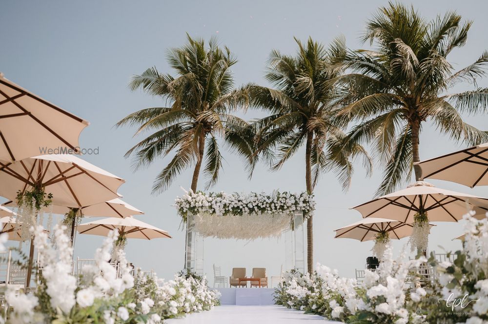 Photo of Gorgeous all white floral madap with a floral aisle for a beach side wedding