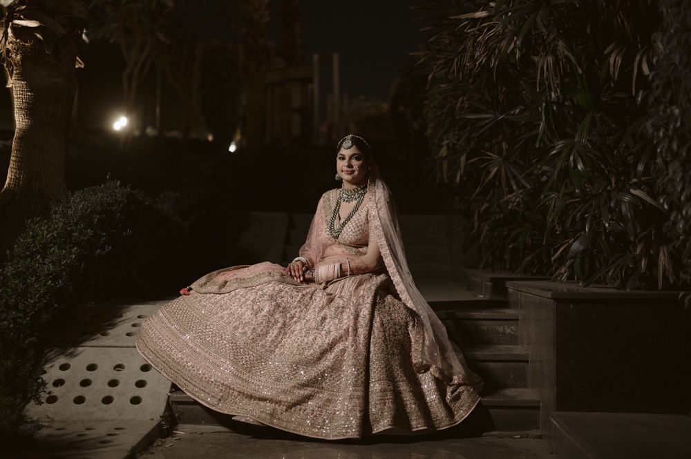 Photo of Unique bridal portrait taken outdoor during night time.
