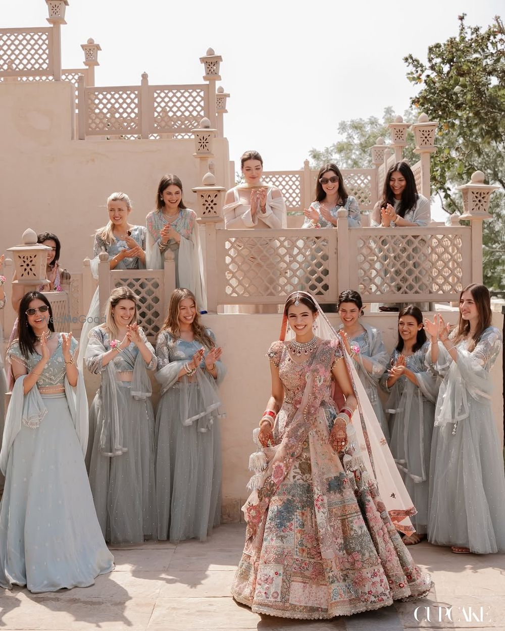 Photo of Lovely bridal shot with co-ordinated bridesmaids in blue and bride in a pastel lehenga