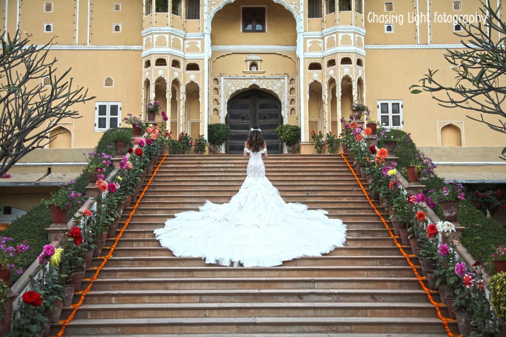 Photo of Bride in Ruffled White Wedding Gown with Dramatic Train
