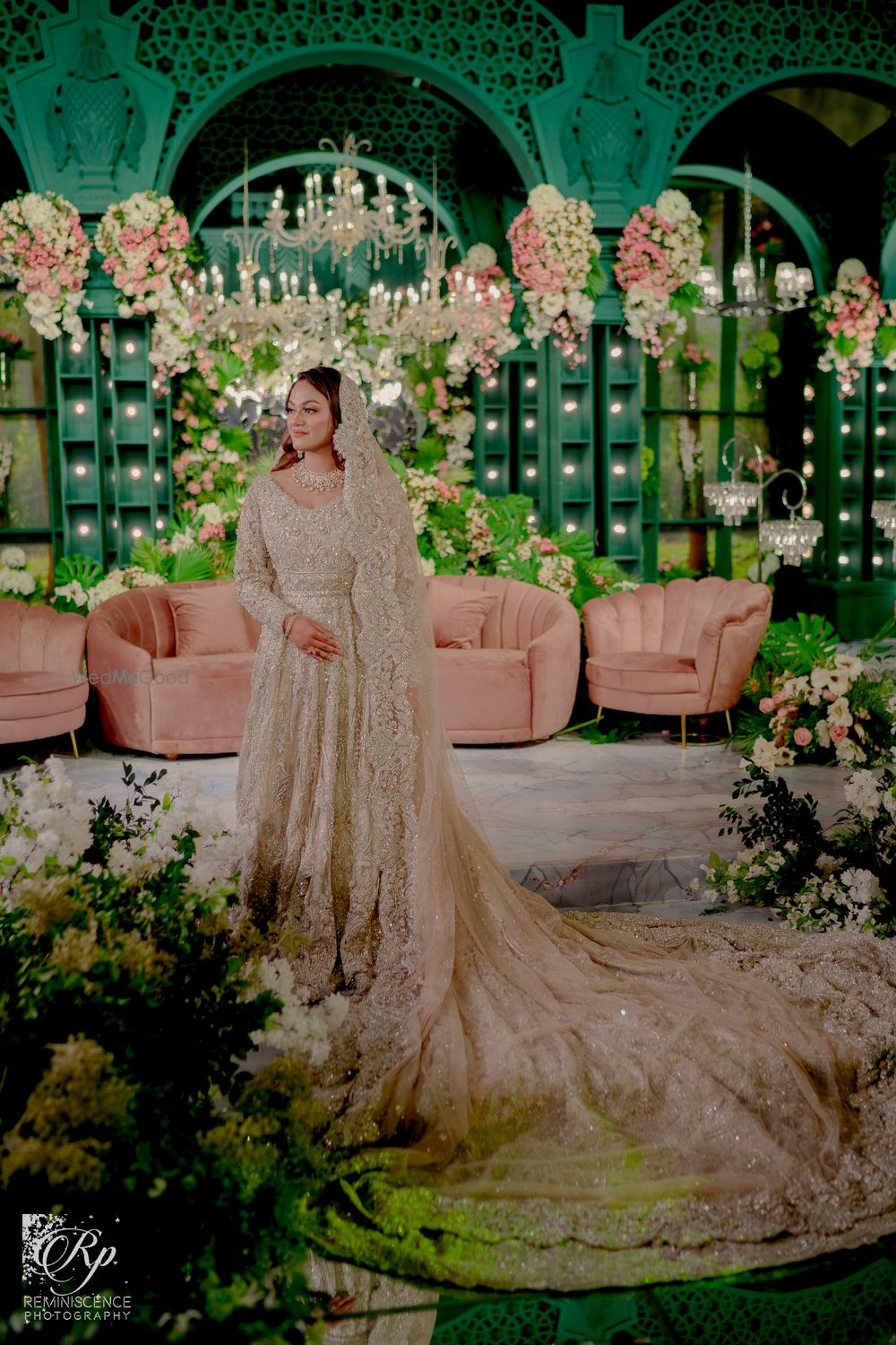 Photo of Muslim bride in a silver gown with a trail