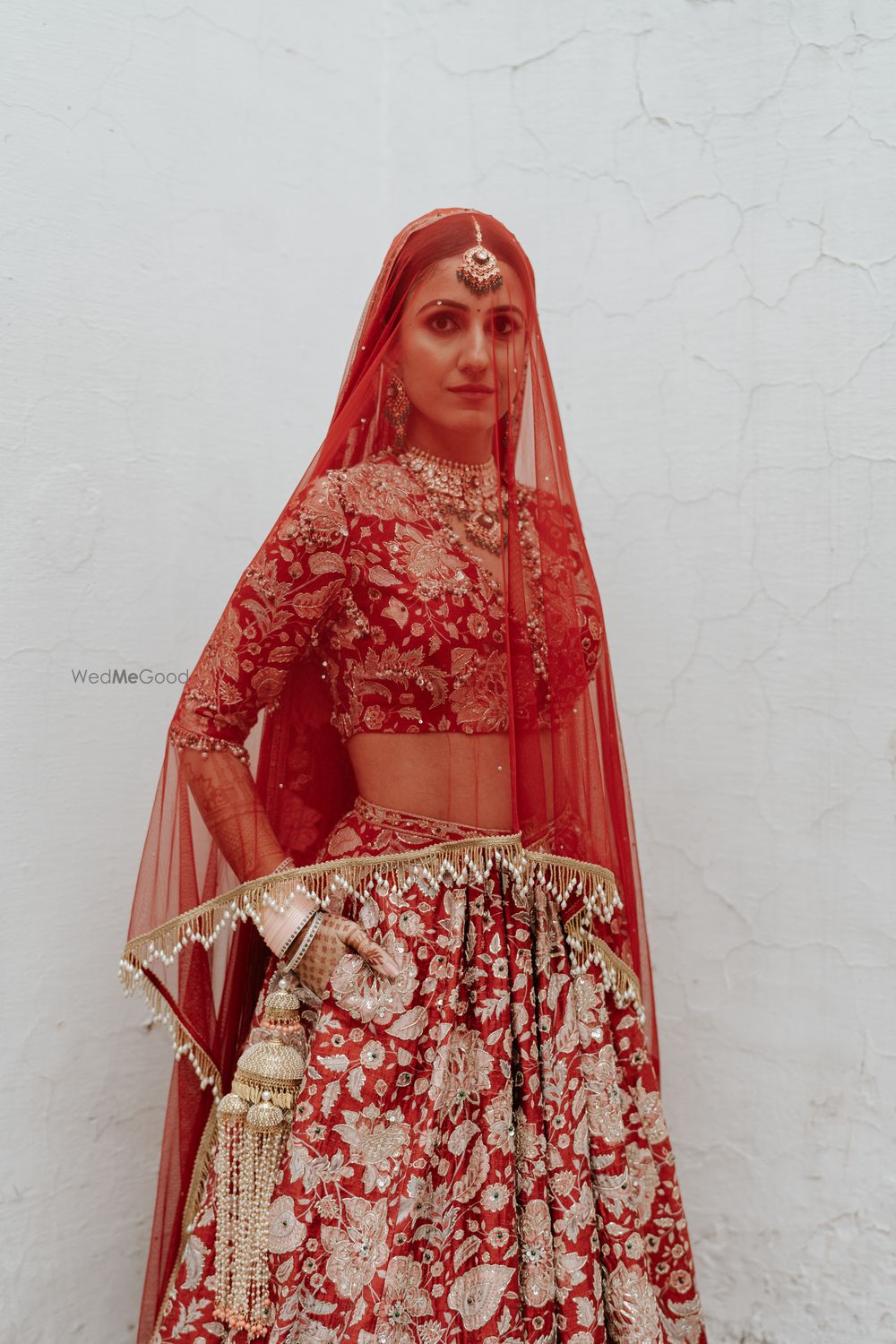 Photo of Stunning red and white bridal lehenga with the dupatta as a veil
