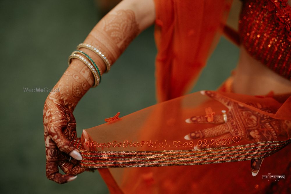 Photo of Bride got her wedding hashtag and wedding date embroidered on her bridal lehenga dupatta