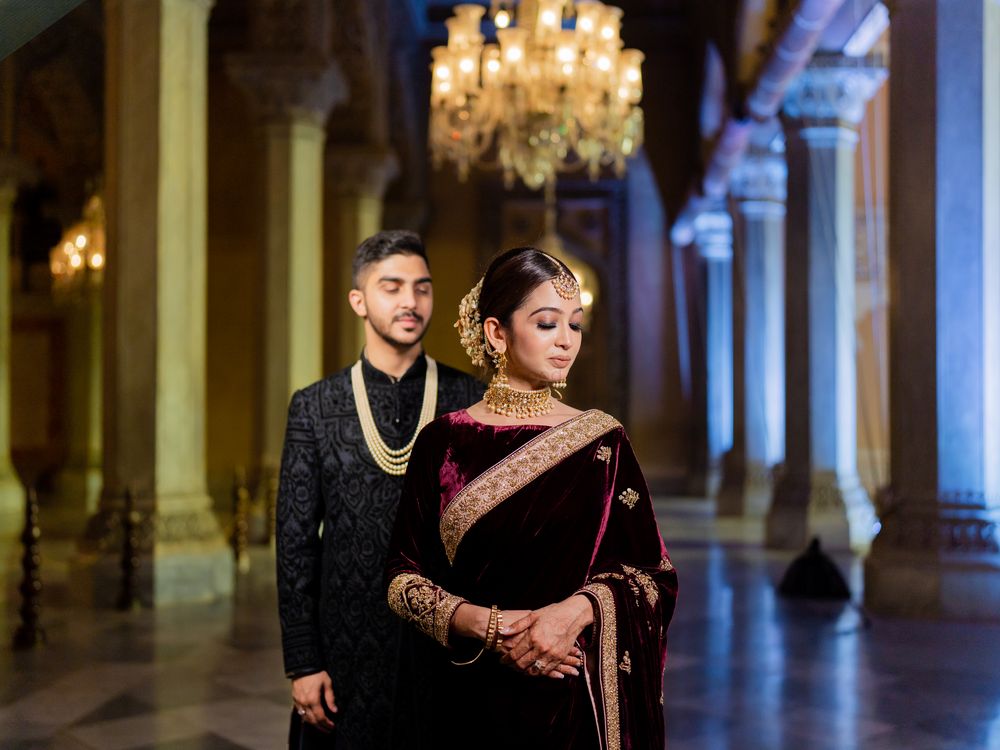 Photo of bride and groom in royal outfits for reception