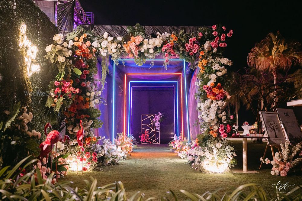 Photo of Fun entrance decor shot with florals and multi-coloured lights