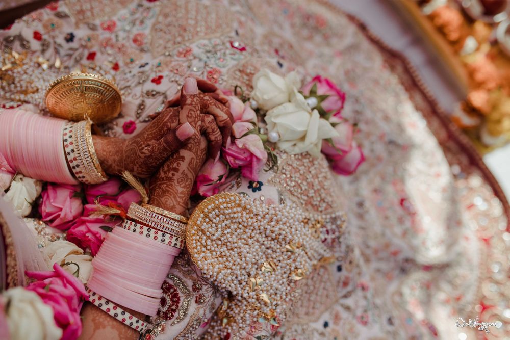 Photo of bridal hands with mehendi pastel choora and kaleere
