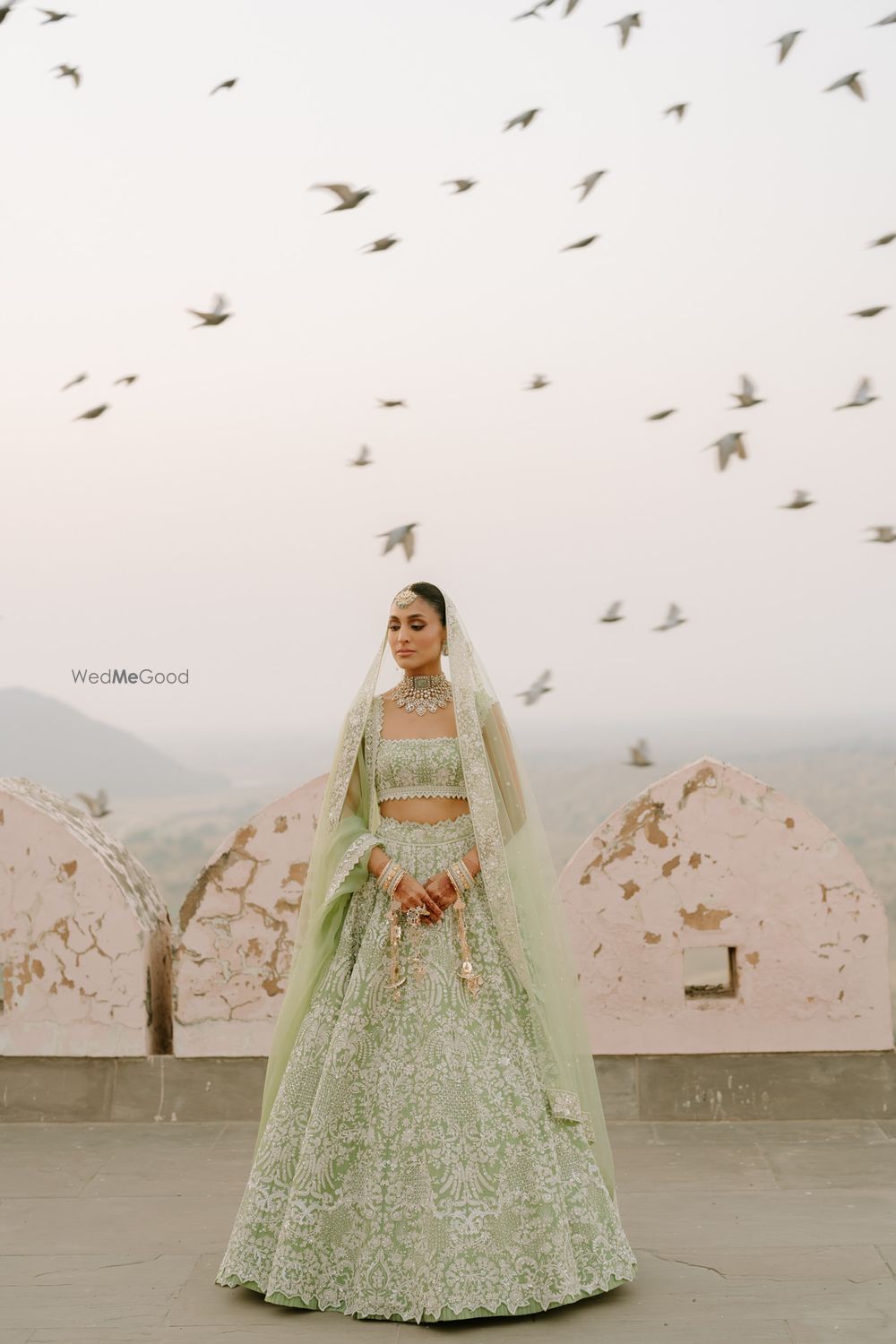 Photo of Bride in a sage green offbeat bridal lehenga