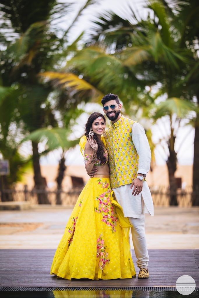Photo of A bride in groom in coordinated yellow mehendi outfits