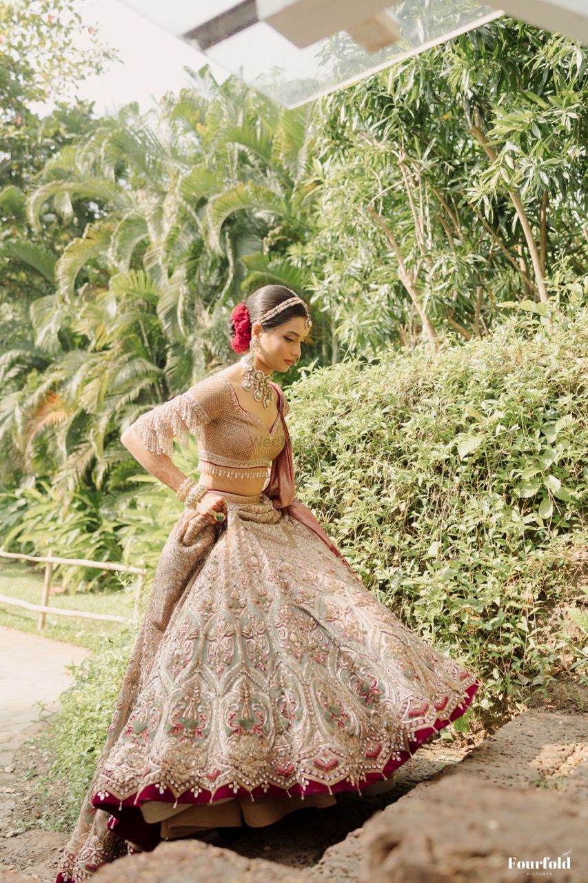 Photo of Pretty shot of the bride walking wearing a stunning grey pink lehenga