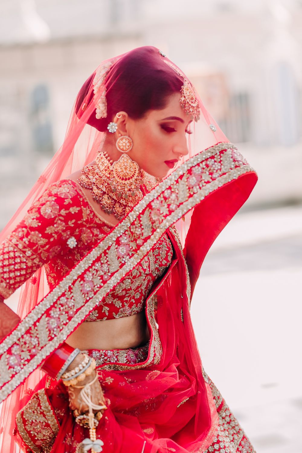 Photo of beautiful bridal portrait idea with the red dupatta as veil